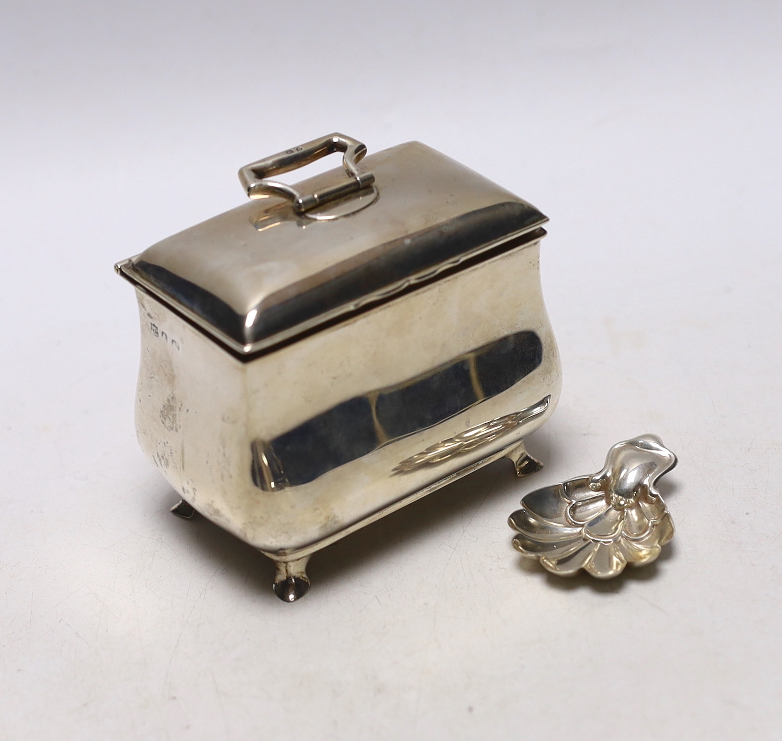 A George V silver bombe shaped tea caddy, S.W. Smith & Co, Birmingham, 1916, width 9cm, together with a later silver caddy spoon.